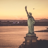 fly with Flynyon over New York City State of Liberty at the sunset